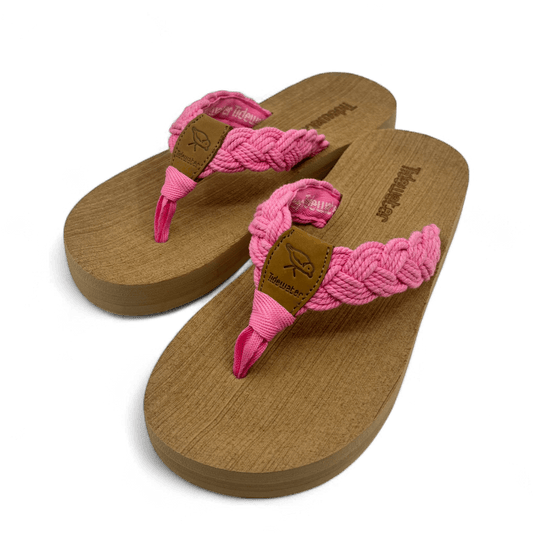 Pair of flip flops with tan comfort footbed and braided bubblegum pink straps with leather accent and soft toe post


