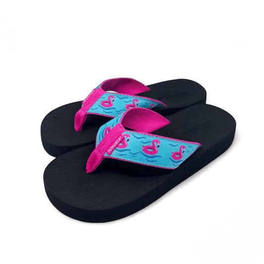 Pair of flip flops with black footbed, bright pink straps, and turquoise strap design featuring pink flamingo floats and wave details