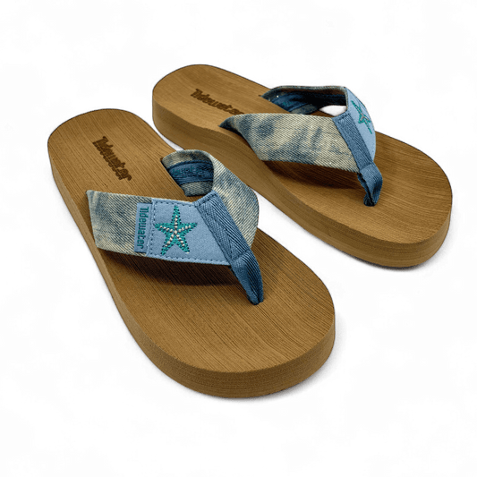 Pair of denim flip flops with teal embroidered starfish on light blue straps and brown comfort footbed

