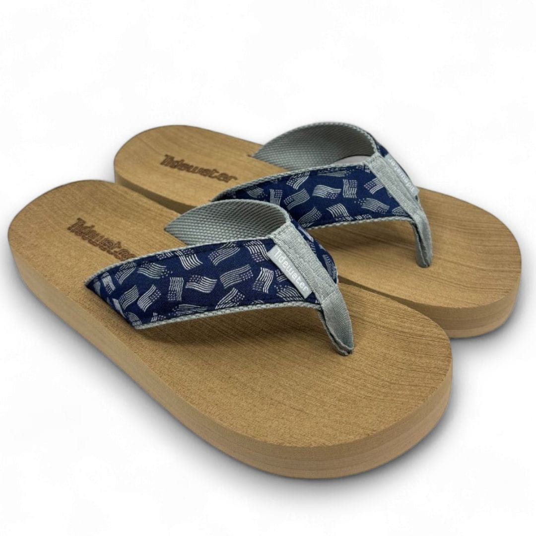 Pair of sandals with wooden sole and blue patterned strap on a white background